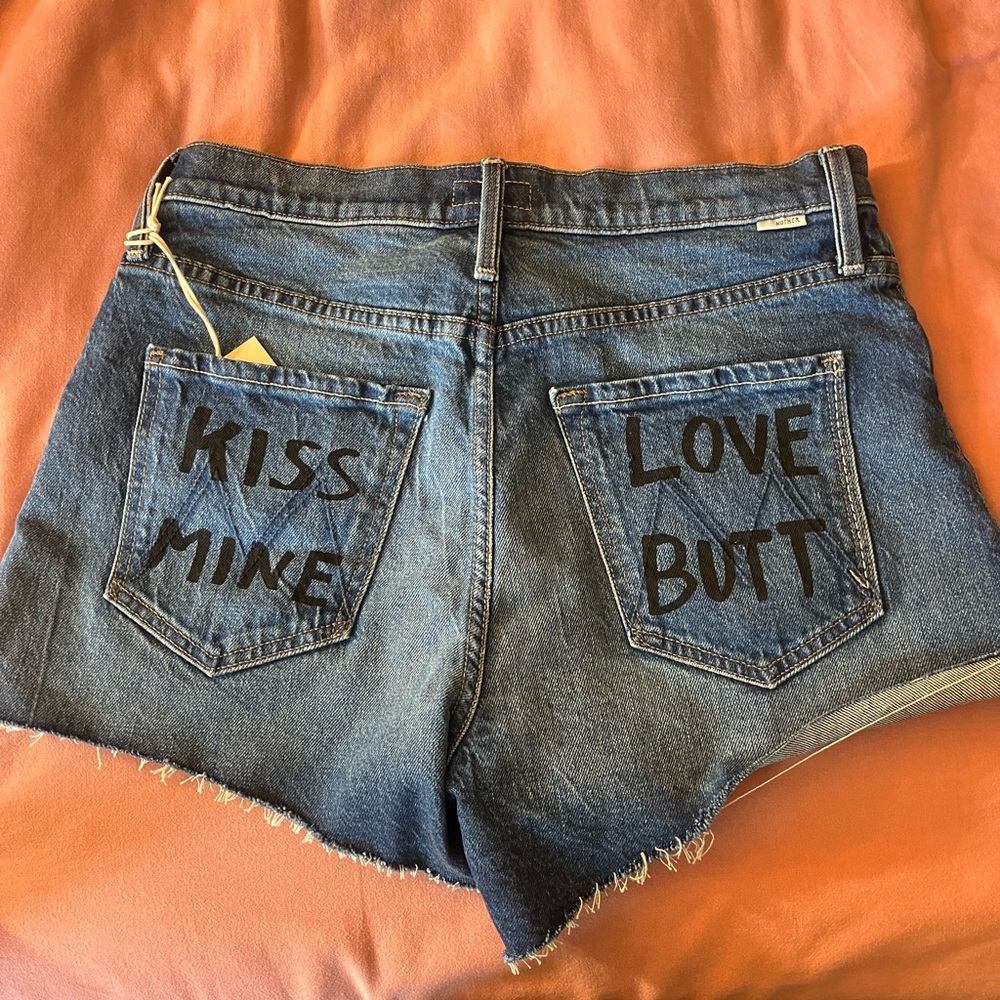 MOTHER Blue Jean Shorts with Distressed Hem and Graphic Text